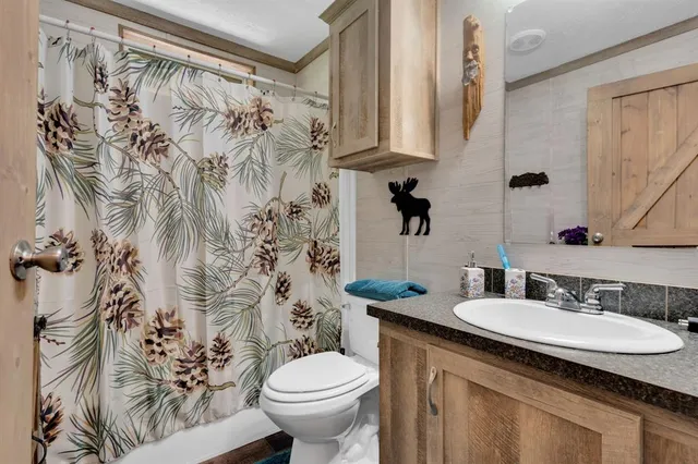 a bedroom with a bed and a lamp on the dresser