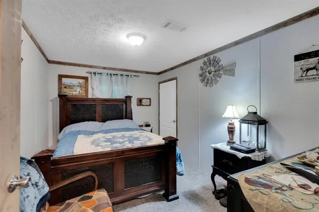 a bedroom with furniture and a flat screen tv