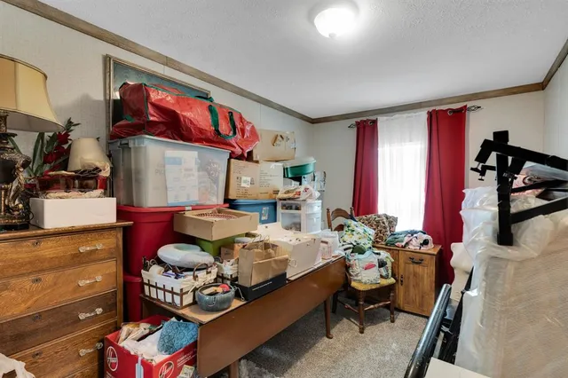 a view of a hallway with workspace and a window