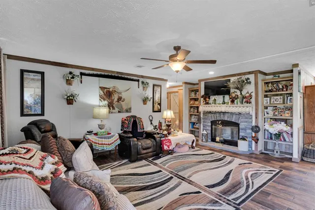 a bedroom with furniture and a large window