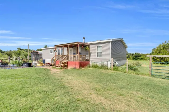 a view of a porch with furniture and garden view