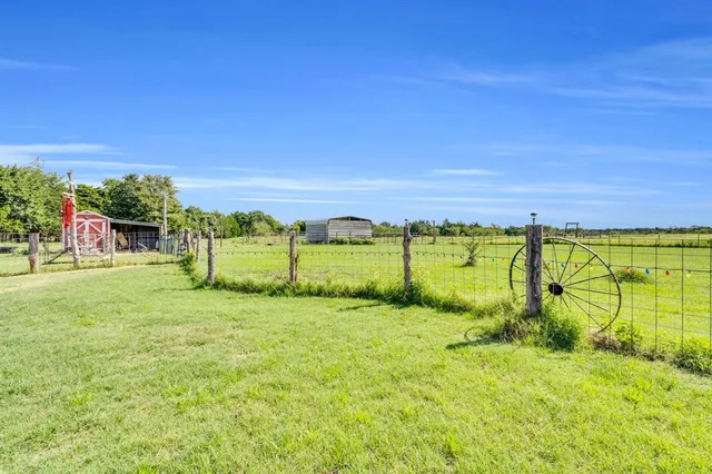 a view of a field with an trees