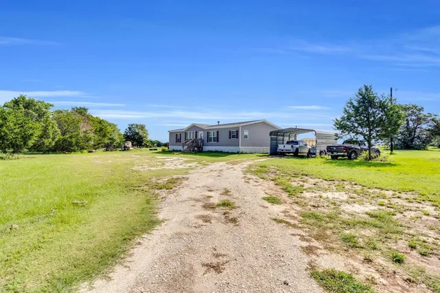 an aerial view of a house with a lake view