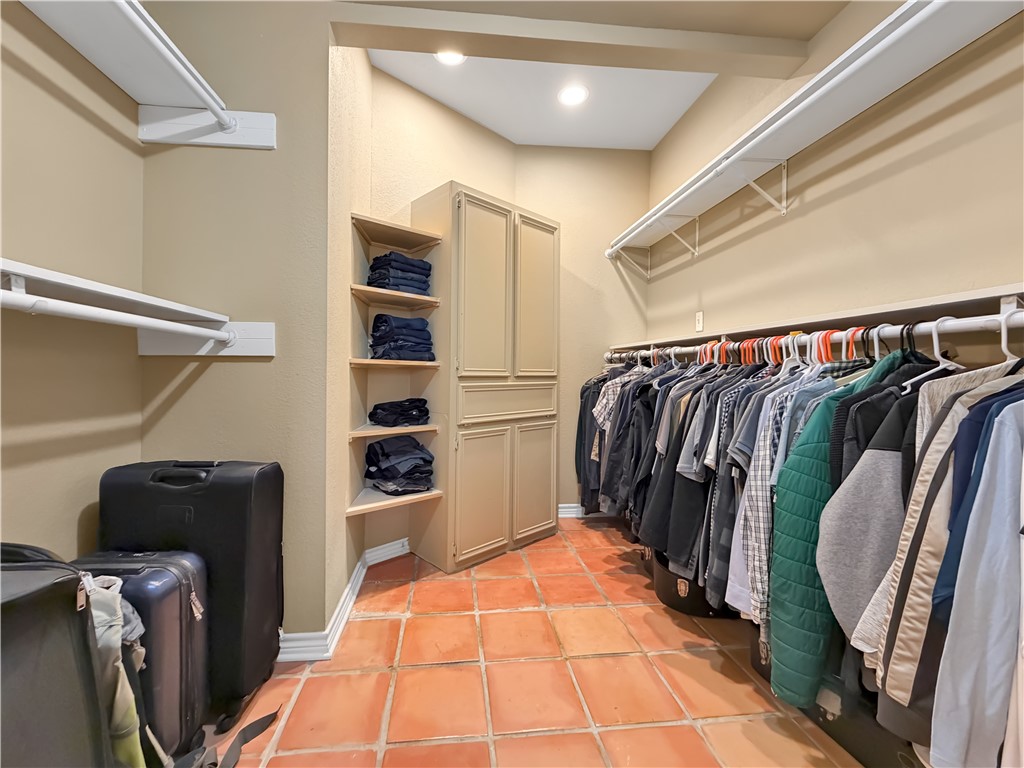 4214 Valley Circle Corpus Christi, TX 78413 - Photo 12 of 28 a view of walk in closet with clothes and shoes
