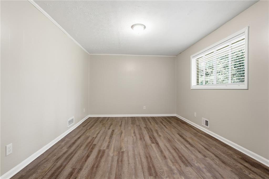 4505 Wonder Valley Trail Decatur, GA 30034 - Photo 10 of 34 an empty room with wooden floor and windows
