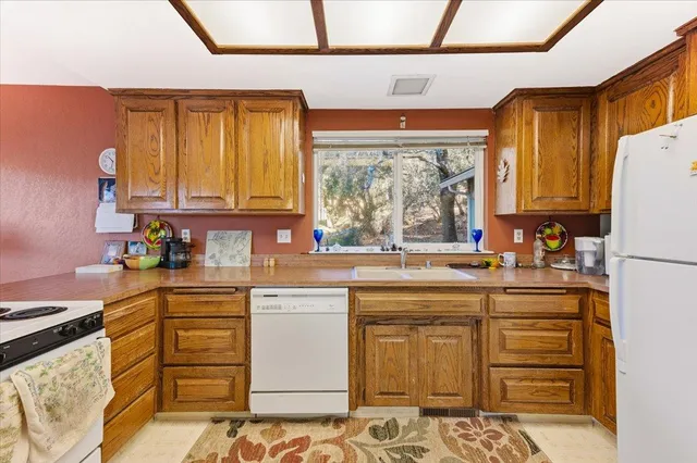 a kitchen with a sink window and cabinets