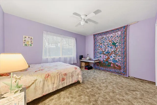 a spacious bedroom with a bed and a window