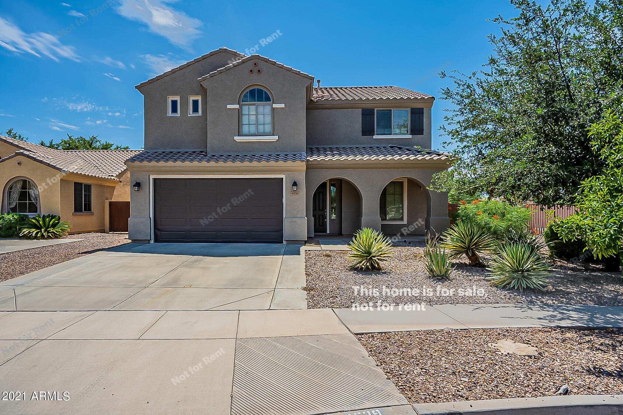 4639 East Timberline Road Gilbert, AZ 85297 - Photo 1 of 33 a front view of a house with a garden