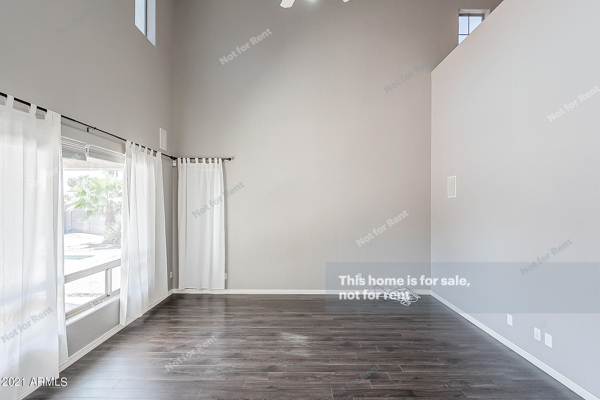 4639 East Timberline Road Gilbert, AZ 85297 - Photo 13 of 33 a view of an empty room with wooden floor and a window