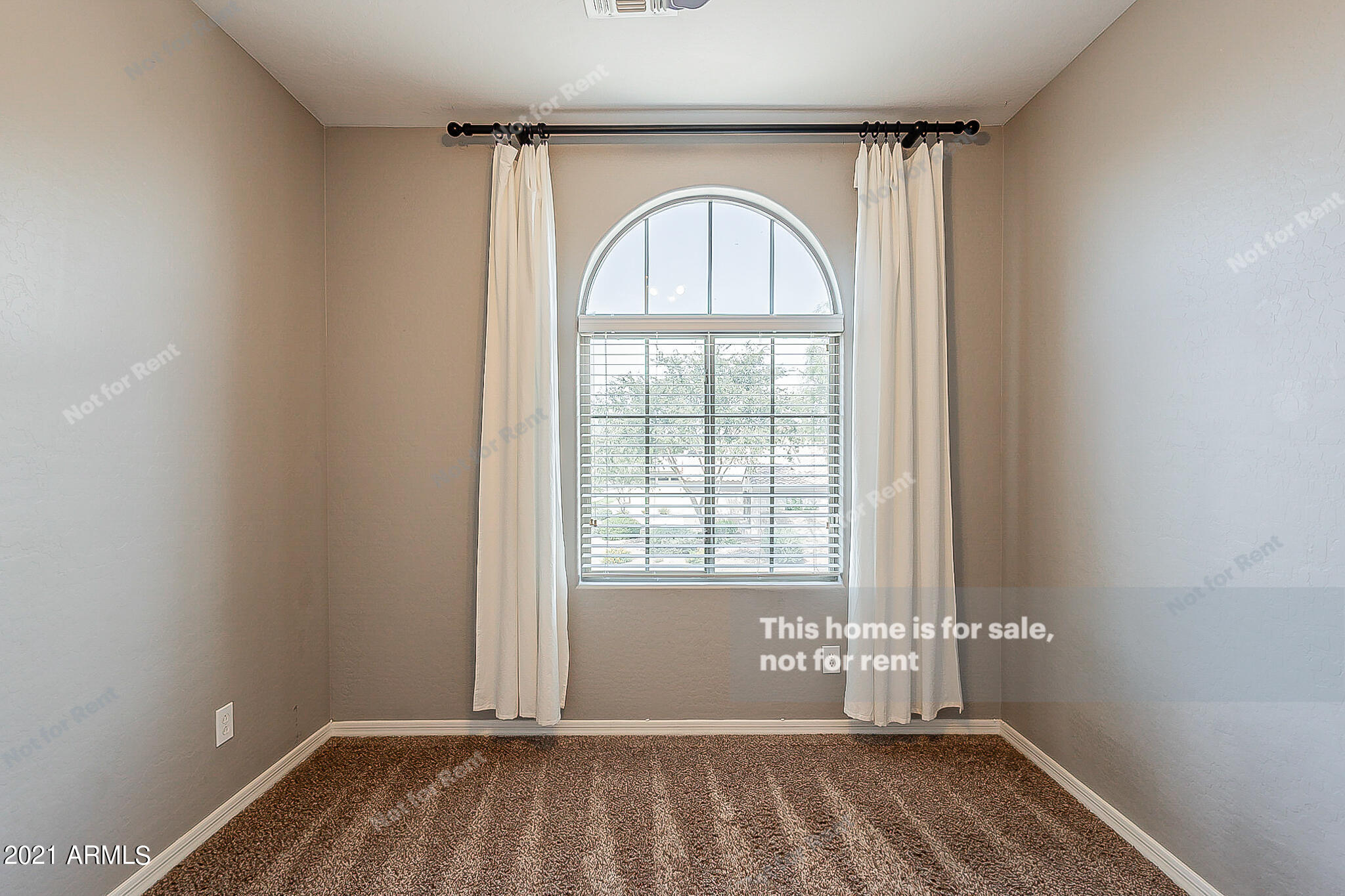 4639 East Timberline Road Gilbert, AZ 85297 - Photo 25 of 33 an empty room with wooden floor fan and windows