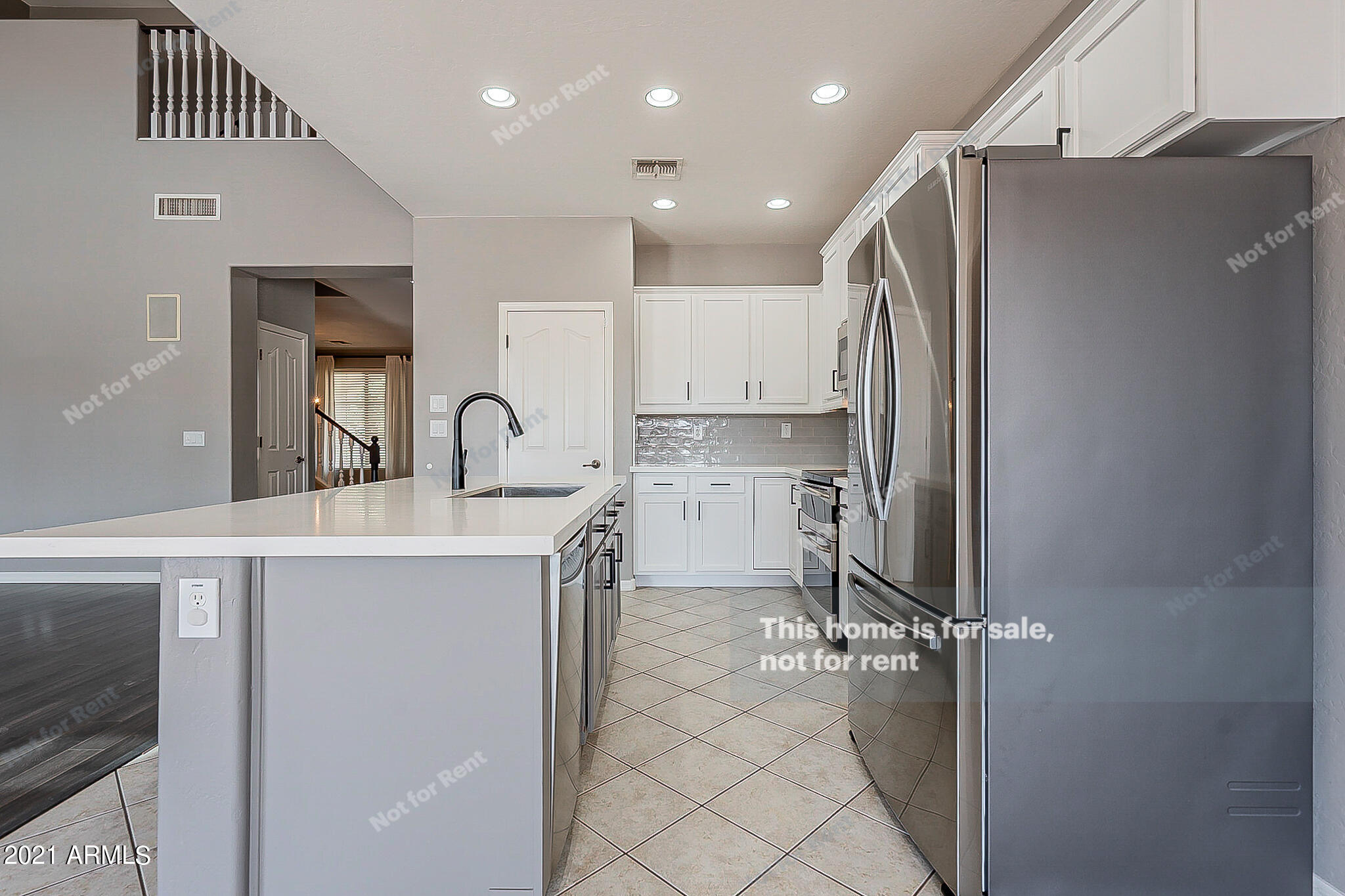 4639 East Timberline Road Gilbert, AZ 85297 - Photo 8 of 33 a kitchen with stainless steel appliances a refrigerator and a sink