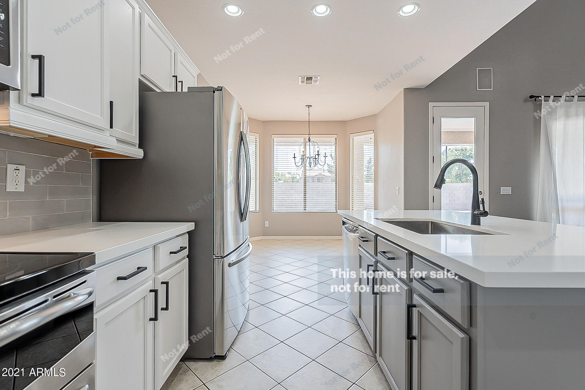 4639 East Timberline Road Gilbert, AZ 85297 - Photo 9 of 33 a kitchen with a sink stove and refrigerator