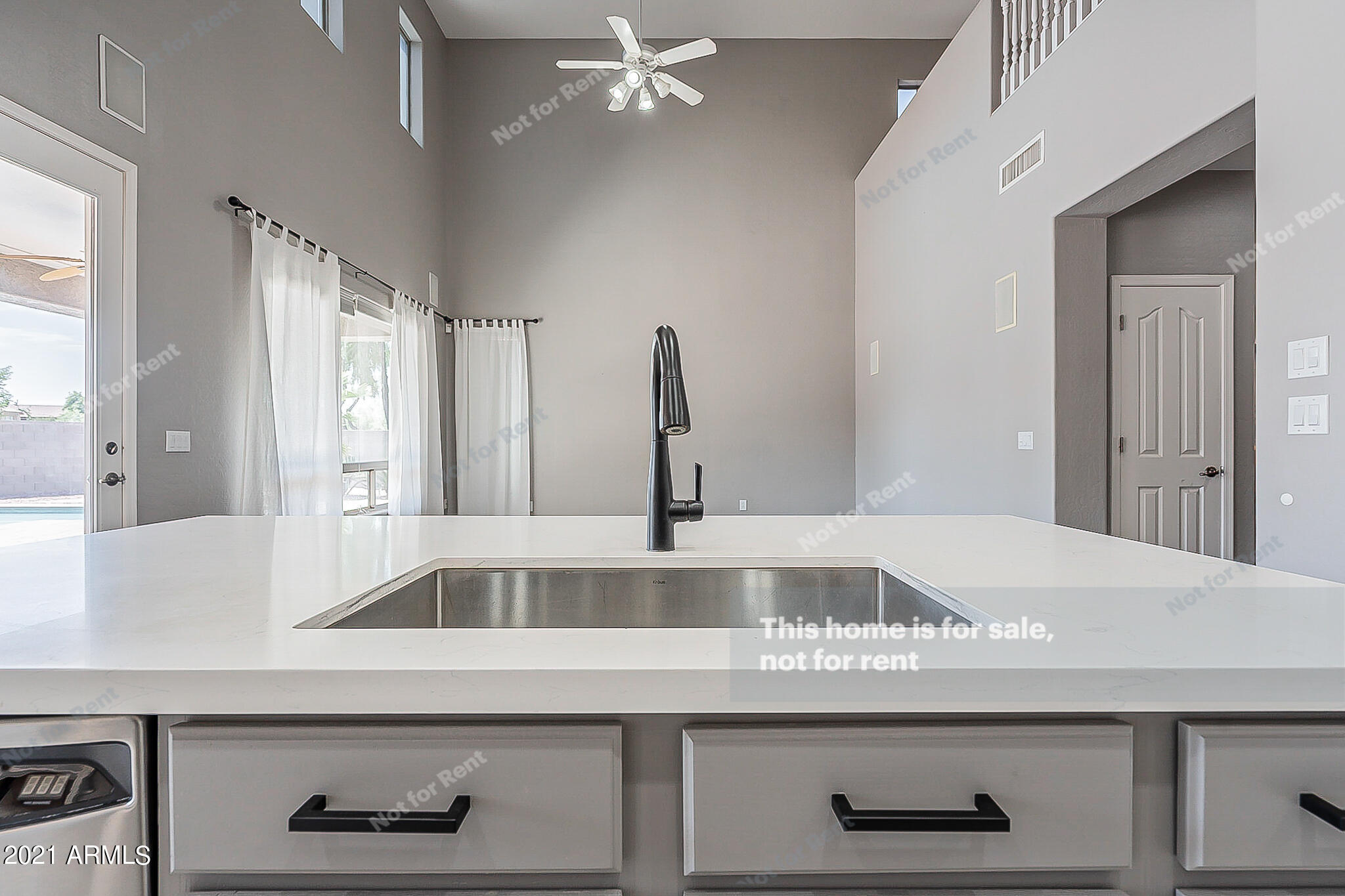 4639 East Timberline Road Gilbert, AZ 85297 - Photo 10 of 33 a kitchen with a sink and a refrigerator