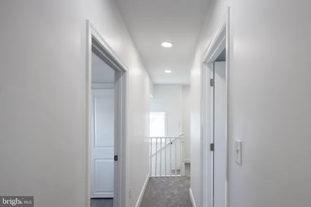 a view of a hallway with closet and front door