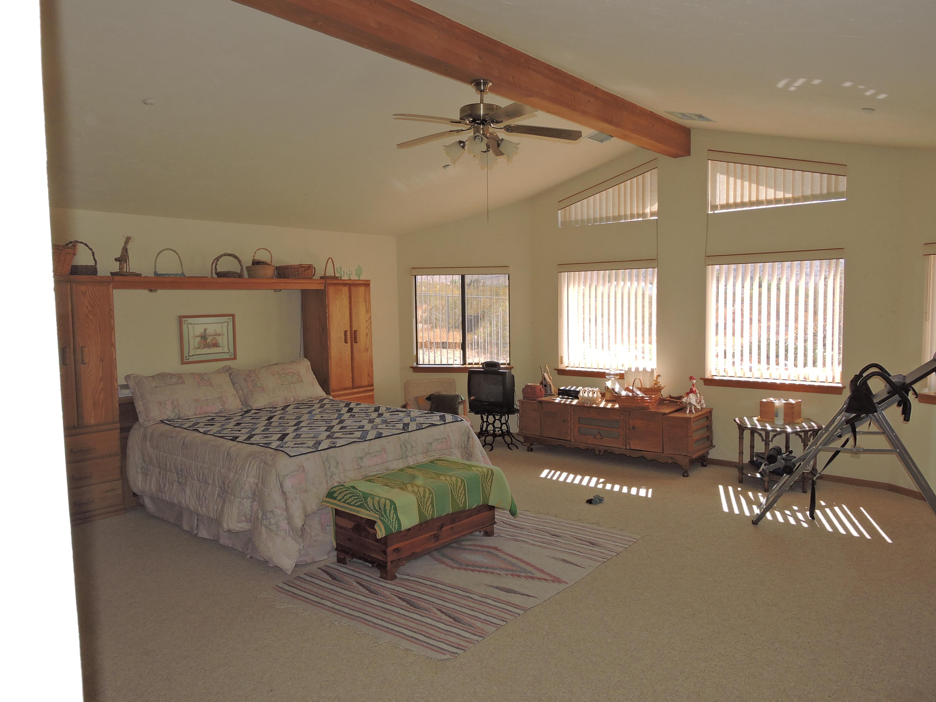 63533 Wagon Wheel Road Joshua Tree, CA 92252 - Photo 20 of 62 a spacious bedroom with a bed a couch and dresser