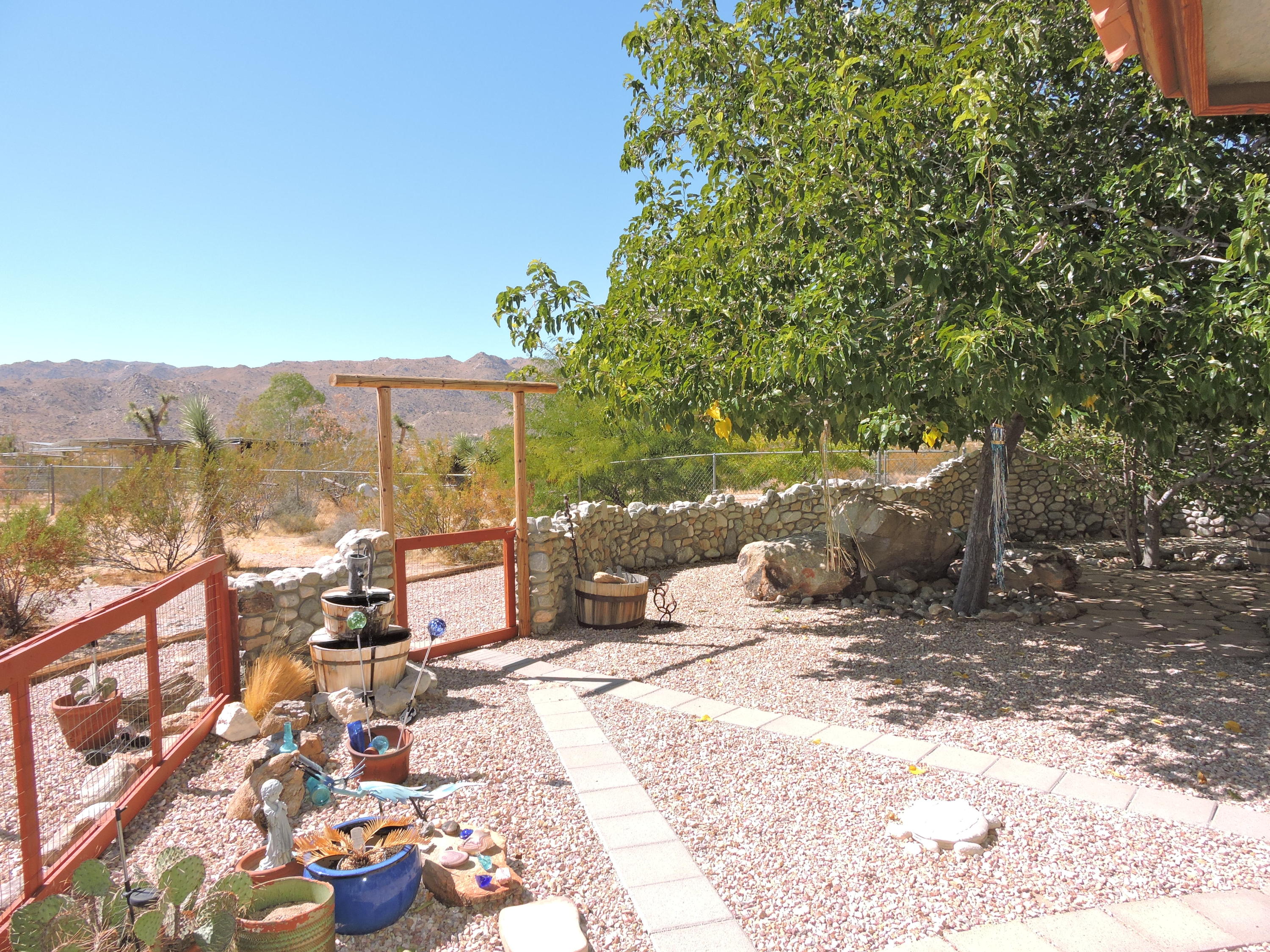 63533 Wagon Wheel Road Joshua Tree, CA 92252 - Photo 28 of 62 a view of a patio with a table and chairs under an umbrella
