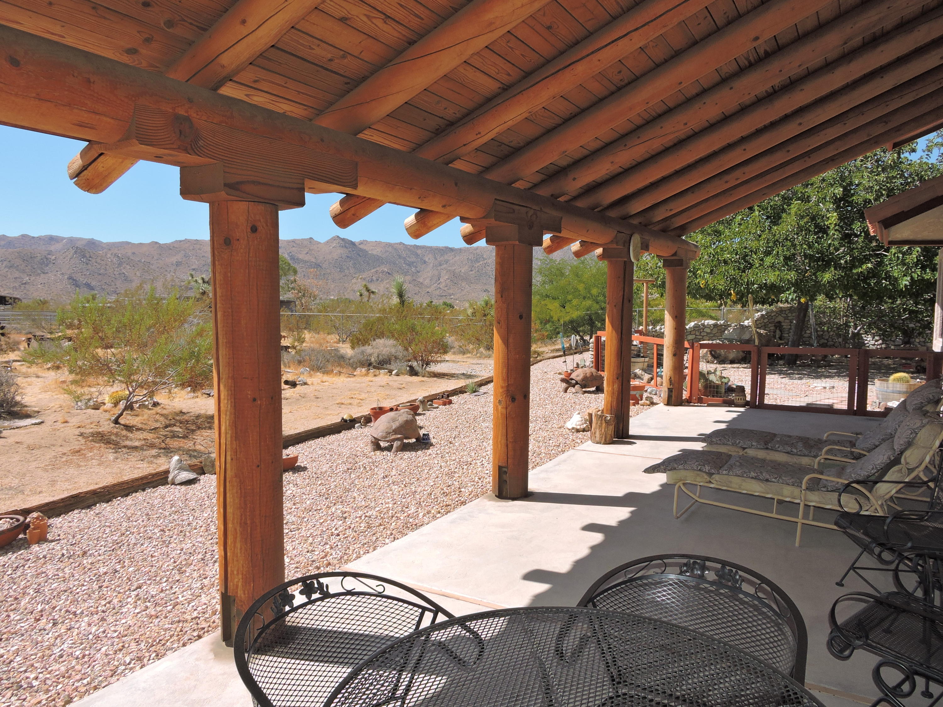 63533 Wagon Wheel Road Joshua Tree, CA 92252 - Photo 50 of 62 a view of a patio with a table chairs and balcony