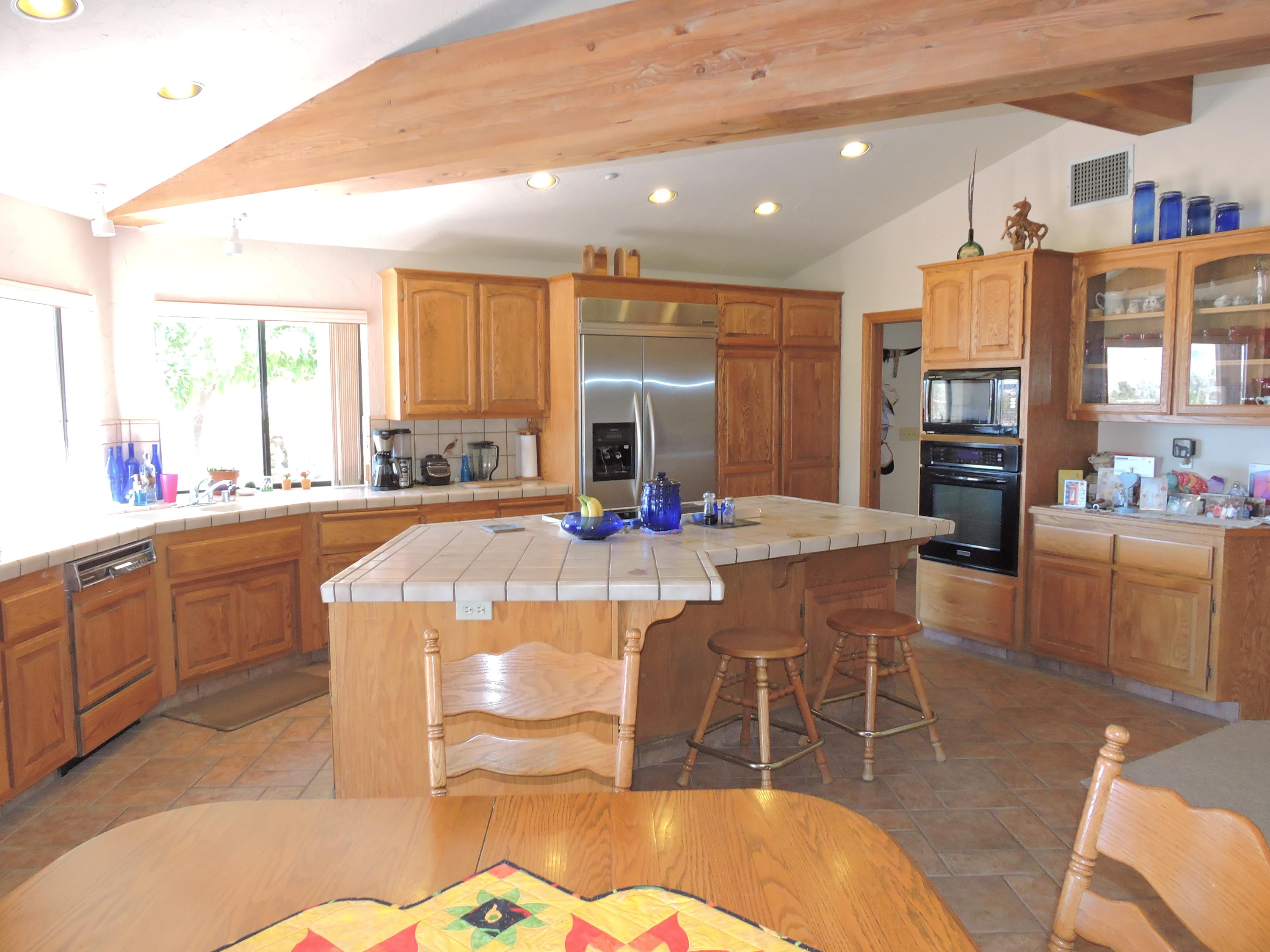 63533 Wagon Wheel Road Joshua Tree, CA 92252 - Photo 10 of 62 a kitchen with stainless steel appliances granite countertop a stove a sink a dining table and chairs