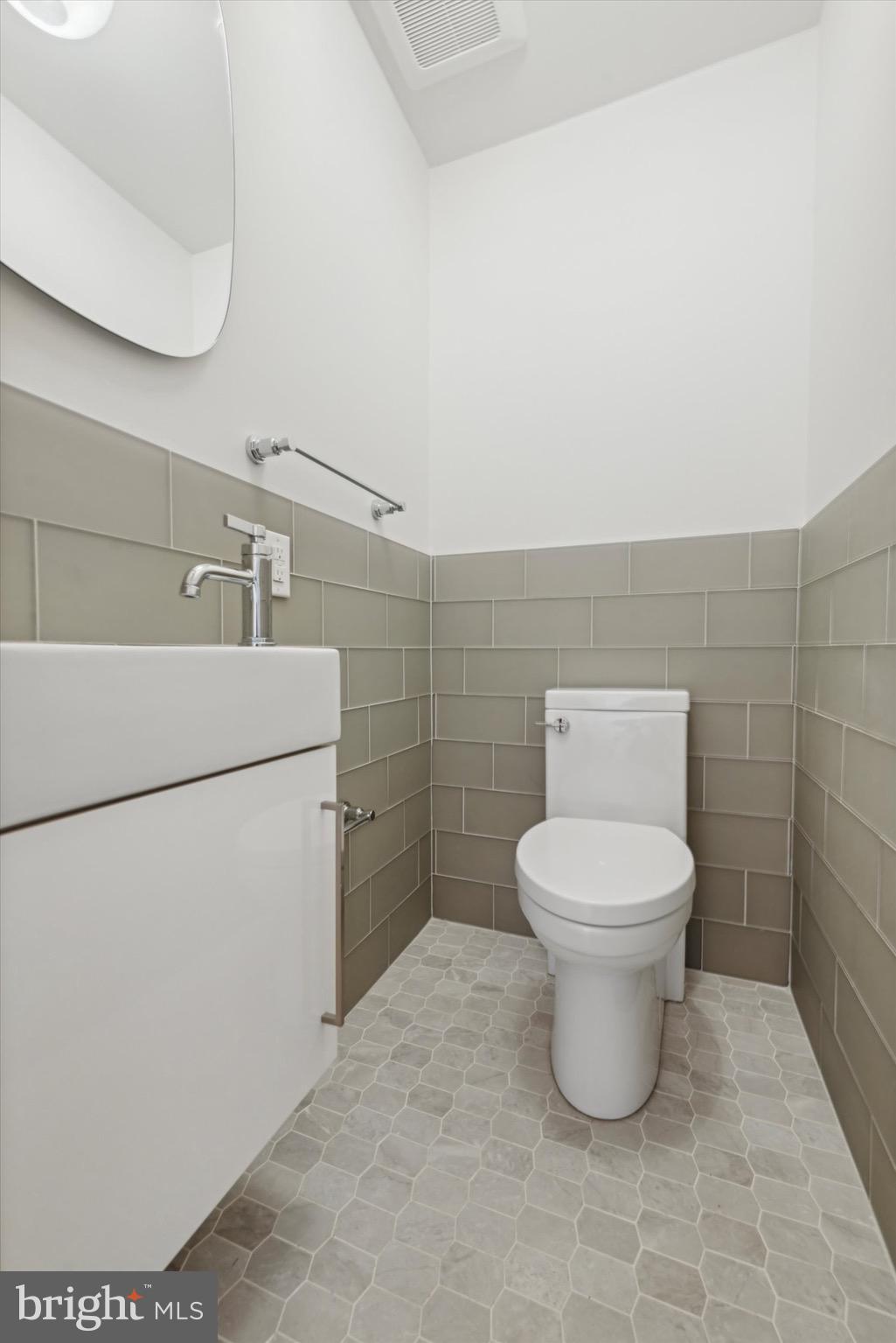 767-769 Newtown Road Villanova, PA 19085 - Photo 14 of 26 a white toilet sitting next to a white sink