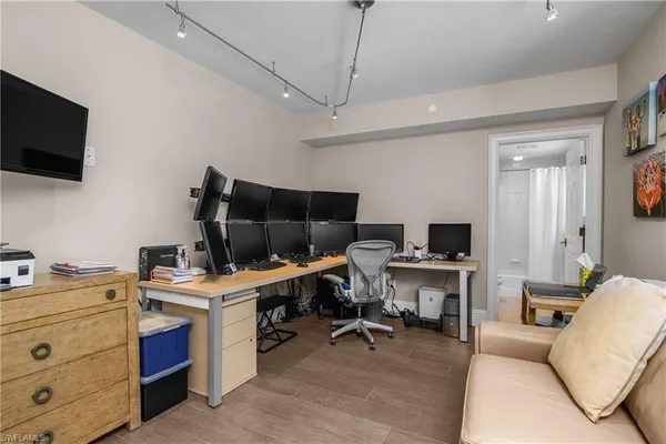 a view of a workspace with furniture and a flat screen tv