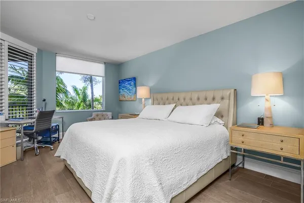 a bedroom with a bed and a lamp on table