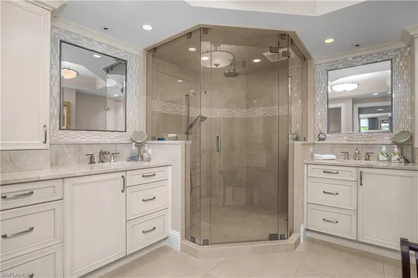 a bathroom with a shower sink and mirror