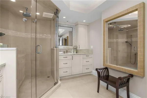 a bathroom with a shower a mirror and a sink