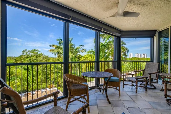 a balcony with chairs and wooden floor