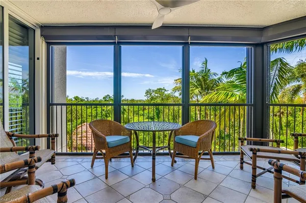 a view of a chairs and table in the balcony