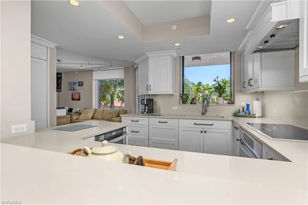 a open kitchen with stainless steel appliances kitchen island granite countertop a sink and cabinets