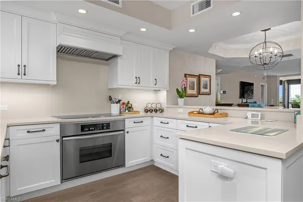 a kitchen with a stove cabinets and window
