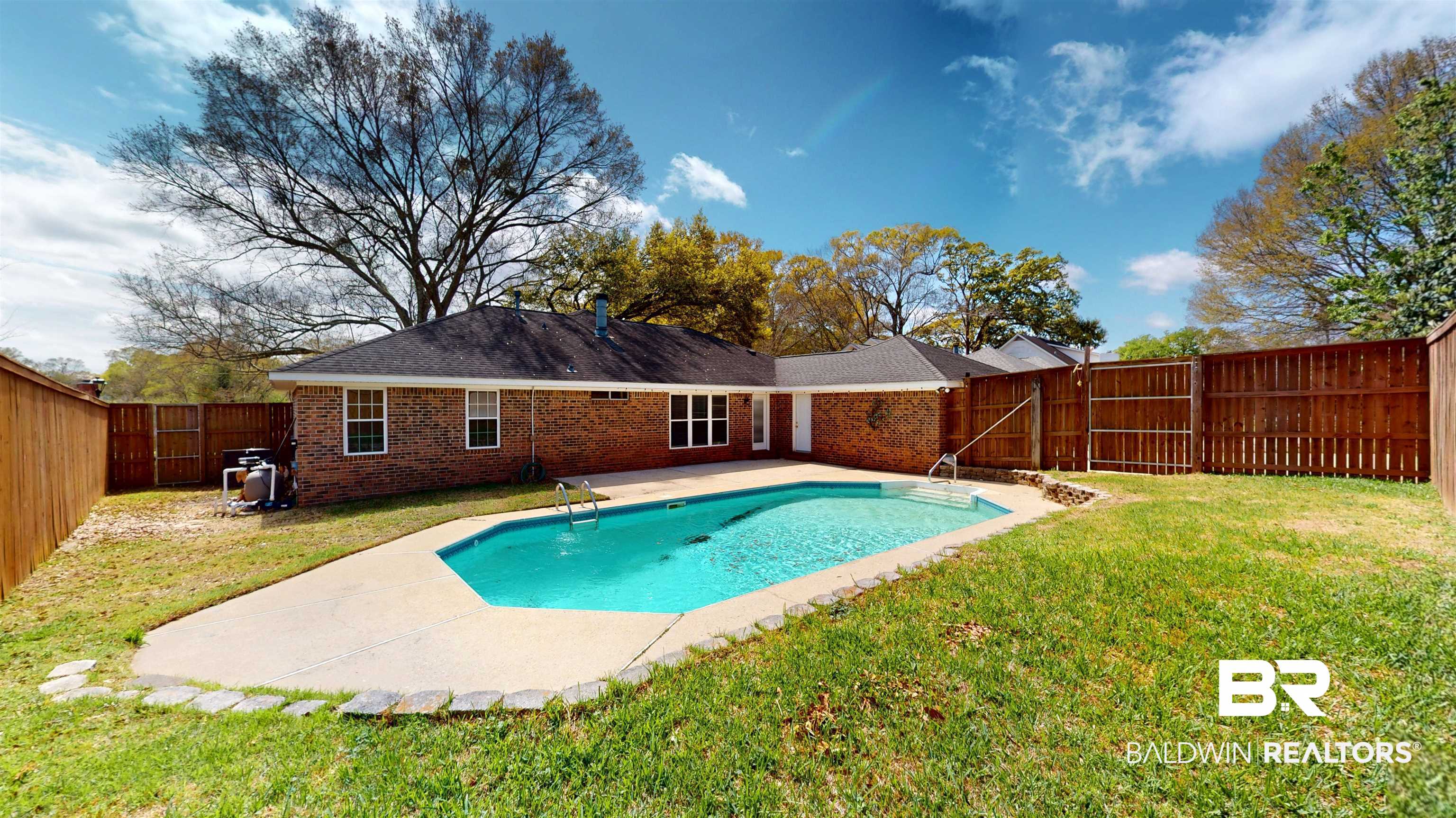 7310 Cheryl Court Mobile, AL 36695 - Photo 14 of 23 Fenced backyard, patio surround, and pool are easily accessed to driveway, garage and den.