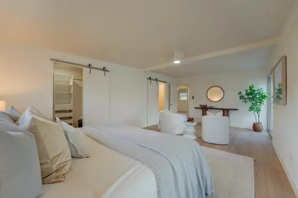 a bed room with a bed and a potted plant