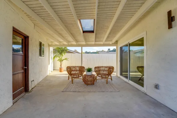 a dining room with furniture and a floor to ceiling window