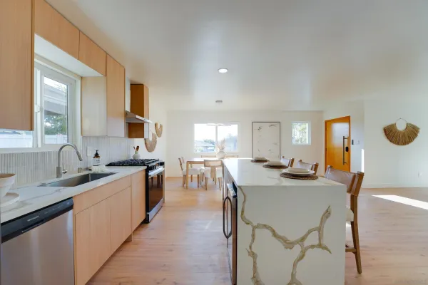 a large kitchen with a table and chairs