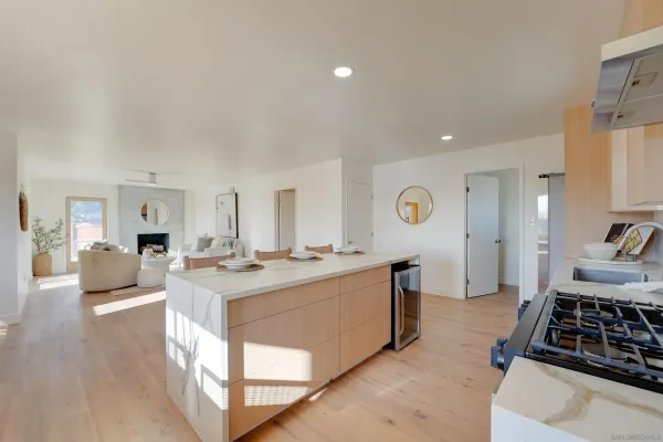 a kitchen with a sink stove and wooden floor
