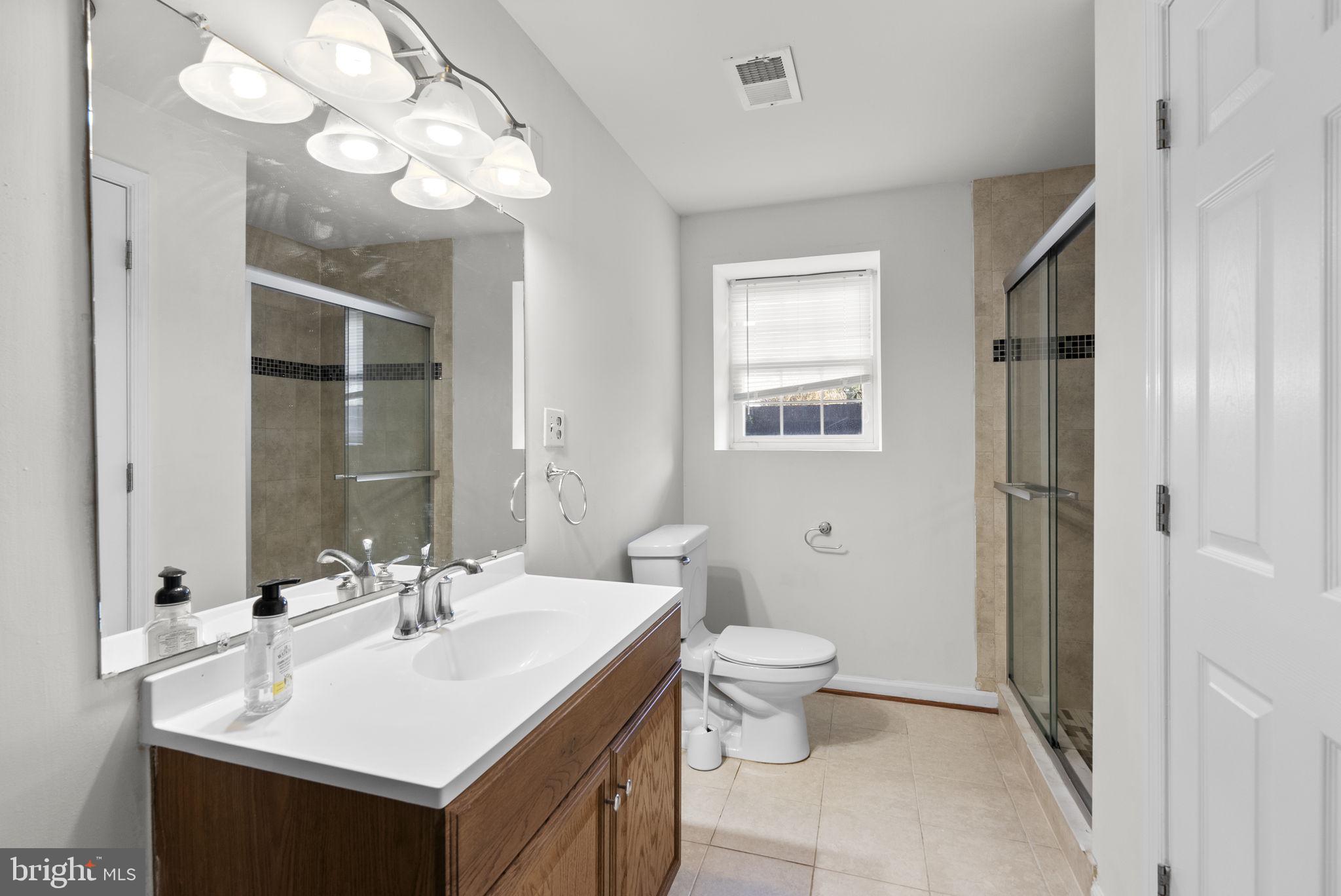 24000 Clarksburg Road Clarksburg, MD 20871 - Photo 45 of 60 a bathroom with a sink a toilet and a mirror