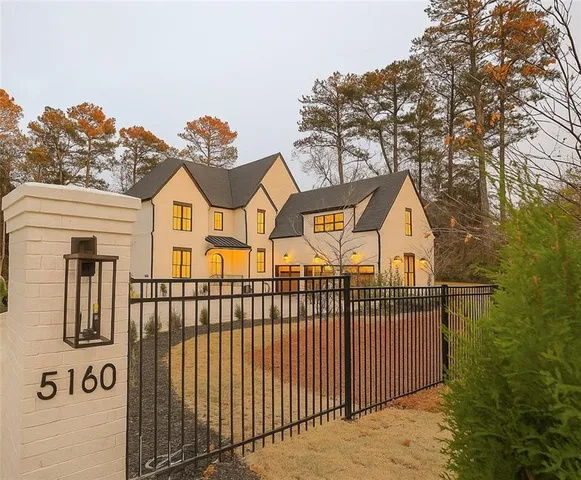 a view of a brick house with large windows