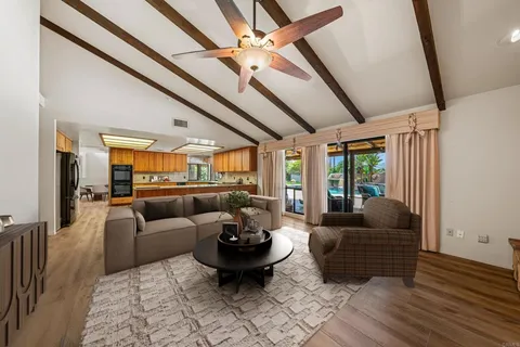 a living room with furniture ceiling fan and a rug