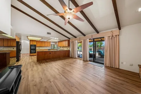 a view of a living room with wooden floor