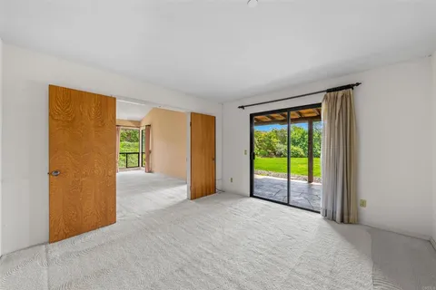 a view of an empty room with large windows