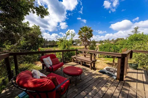 a view of a house with backyard and sitting area