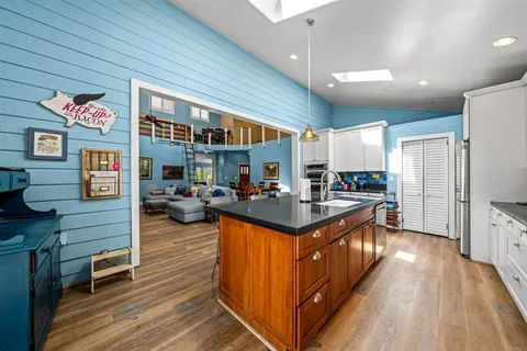 a kitchen with stainless steel appliances granite countertop a stove and a refrigerator