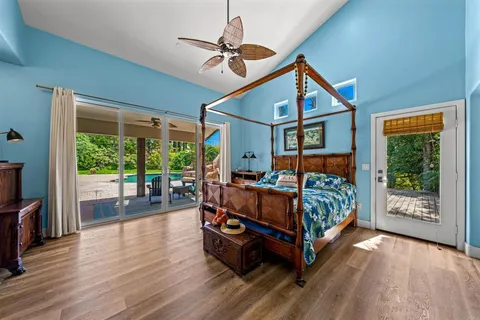 a bedroom with furniture and a large window