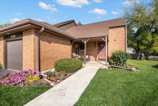 a front view of a house with a yard and outdoor seating