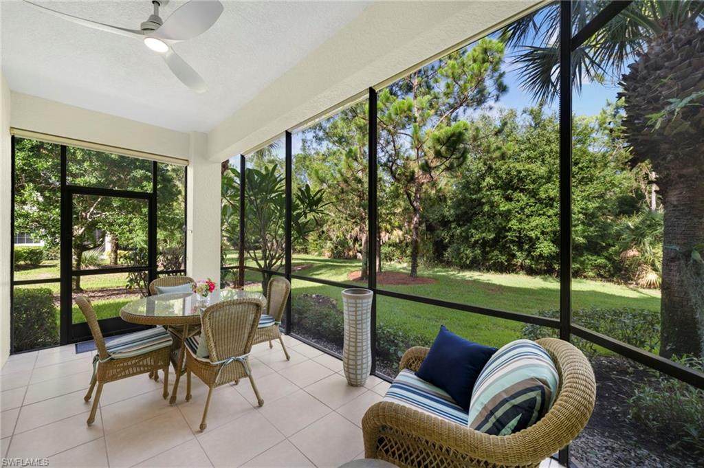 7837 Hawthorne Drive, Unit 1101 Naples, FL 34113 - Photo 1 of 41 a view of a patio with couches chairs and a big yard
