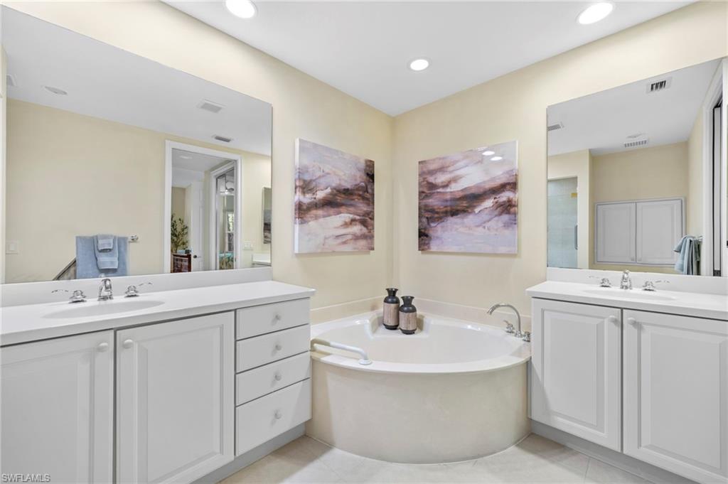 7837 Hawthorne Drive, Unit 1101 Naples, FL 34113 - Photo 13 of 41 a bathroom with a sink and a mirror