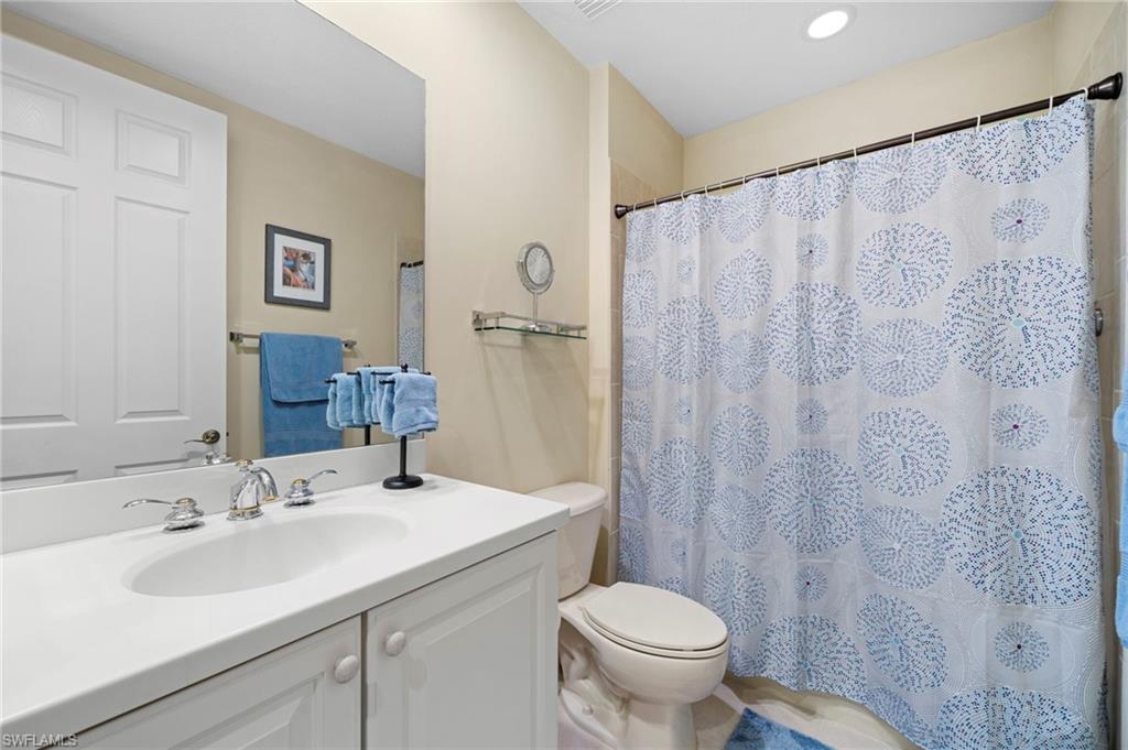 7837 Hawthorne Drive, Unit 1101 Naples, FL 34113 - Photo 14 of 41 a bathroom with a sink and a mirror