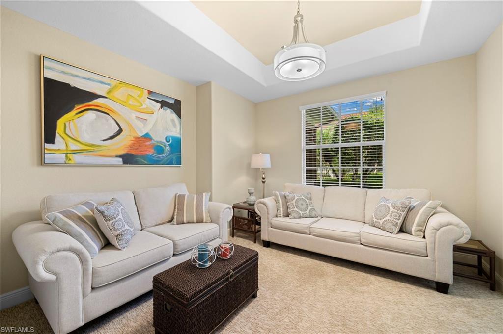 7837 Hawthorne Drive, Unit 1101 Naples, FL 34113 - Photo 19 of 41 a living room with furniture and a window