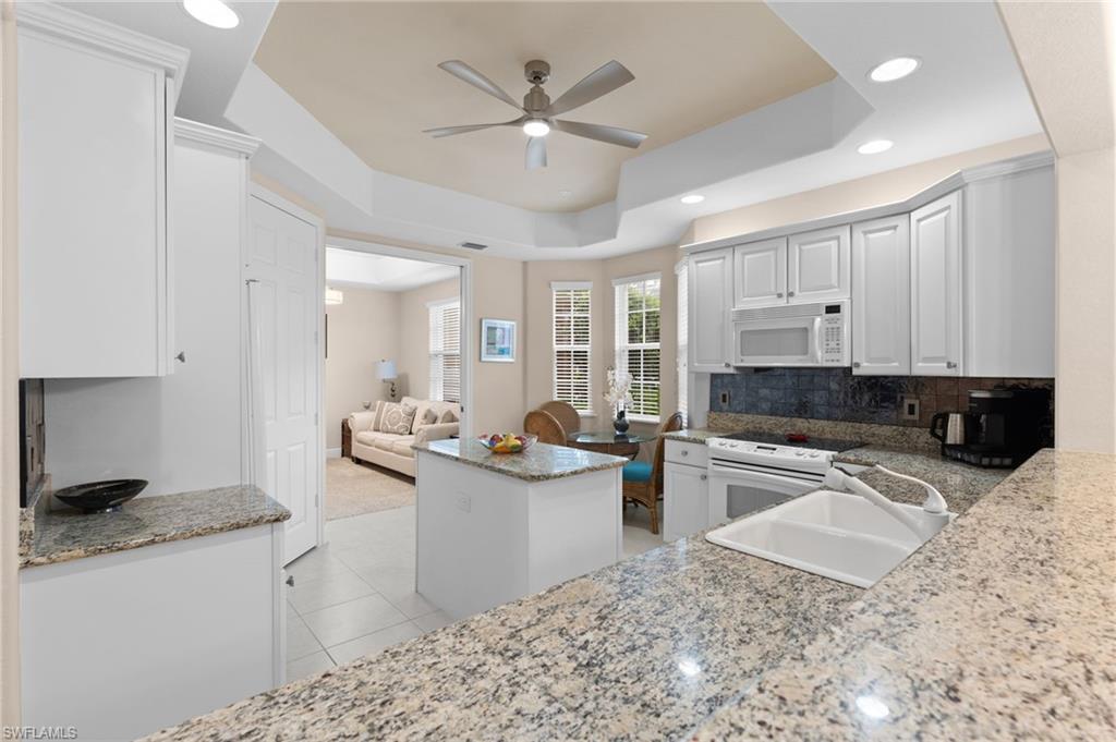 7837 Hawthorne Drive, Unit 1101 Naples, FL 34113 - Photo 22 of 41 a kitchen with stainless steel appliances granite countertop a sink stove and refrigerator